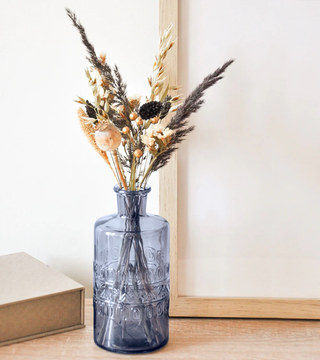 Bouquet of dried flowers in a blue glass vase